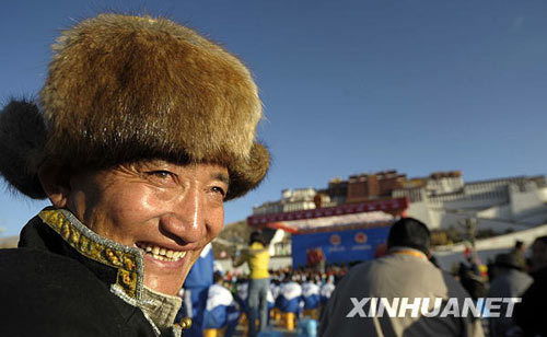 A Tibetan man smiles prior to the celebration ceremony to mark the first Serfs Emancipation Day in front of Potala Palace in Lhasa, capital of southwest China's Tibet Autonomous Region, on March 28, 2009. A grand celebration ceremony will be held here at 10:00 a.m. local time Saturday to mark the first Serfs Emancipation Day. 