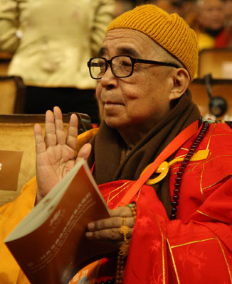 An aging Buddhist takes a seat in the conference hall, also called the Altar, Fangong Palace, Linshan Mountain, in Wuxi, Jiangsu Province, where the Second World Buddhist Forum, attended by over 1,000 monks from more than 50 countries and regions, begins today (March 28). 