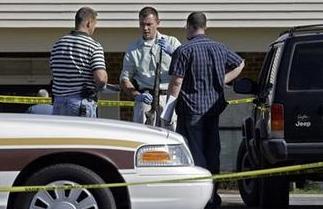 Investigators examine a weapon at the scene where a gunman opened fire at a nursing home Sunday morning, killing at least six people and wounding several others in Carthage, N.C. on Sunday, March 29, 2009.[Gerry Broome/AP Photo] 