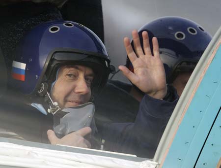 Russia's President Dmitry Medvedev waves from the cockpit of a Sukhoi SU-34 fighter-bomber before a flight during his visit to the Kubinka airbase outside Moscow March 28, 2009.