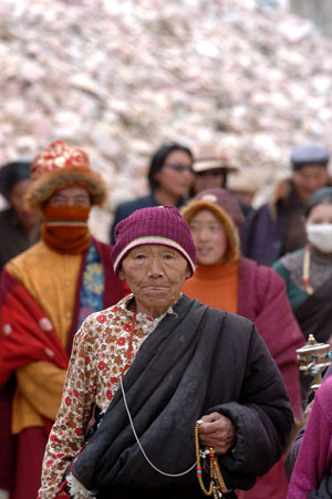 A senior takes ritual walks around the Jiana Mani Stone Mound in Xinzhai Village, Yushu County, Tibetan Autonomous Prefecture of Yushu, northwest China's Qinghai Province, on March 24, 2009.