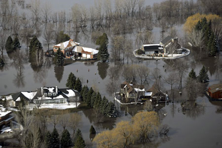 An aerial view shows homes on the southside of Fargo, North Dakota in the Briarwood neighborhood surrounded by flood waters March 29, 2009.