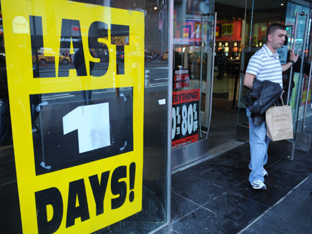 A customer walks out of the Virgin Megastore at Times Square in New York, the United States, March 29, 2009. 