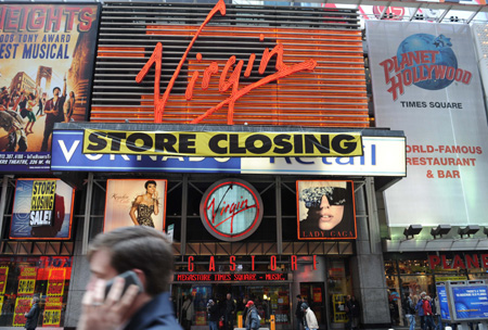 The scroll of 'store closing' blares on the facade of the Virgin Megastore in Times Square in New York, the United States, March 29, 2009. 