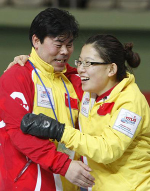 Team China skip Wang Bingyu (R) and her team coach Tan Weidong celebrate after they beat Sweden in the final at the 2009 World Women's Curling Championship in Gangneung, east of Seoul March 29, 2009.