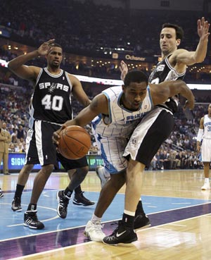 New Orleans Hornets forward Hilton Armstrong (12) is fouled by San Antonio Spurs guard Manu Ginobili (20) during the first half of their NBA basketball game in New Orleans, Louisiana March 29, 2009. 