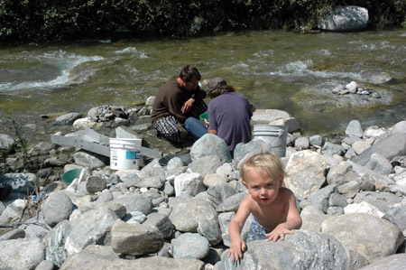 A kid crawls on rocks while his parents seek for gold in the San Gabriel Mountains, Los Angeles, California, the United States, March 29, 2009. 