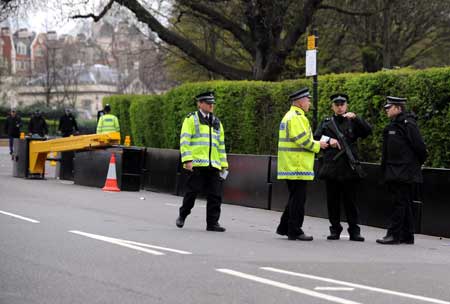 Policemen stand guard on a closed road beside the Winfield House, the official residence of the United States ambassador to Britain where U.S. President Barack Obama will stay during the summit of the Group of 20 Countries (G20), in London on March 31, 2009.[Xinhua]