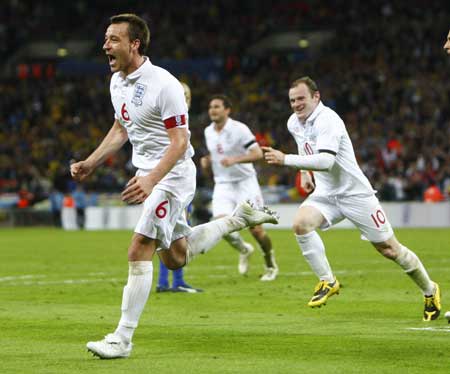 England's John Terry (L) celebrates his goal against Ukraine with Wayne Rooney during their 2010 World Cup qualifying soccer match at Wembley Stadium in London April 1, 2009.