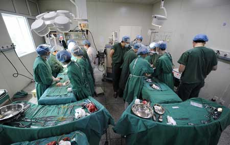 The separation surgery for a pair of conjoined twin girls is underway at Hunan Children's Hospital in Changsha, capital of central China's Hunan Province, April 1, 2009. 