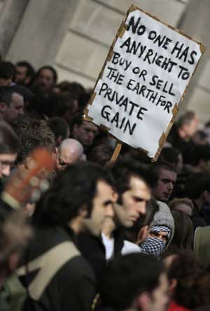 People hold a post while taking part in a protest near the Royal Bank of Scotland in London, Britain, April 1, 2009.