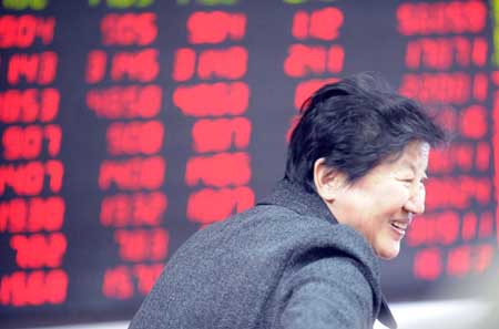 Photo taken on April 1, 2009 shows a woman smiles before a stock price electronic board in Beijing. China's benchmark composite stock index on the Shanghai Stock Exchange closed at 2408 points on Tuesday. [Xinhua]