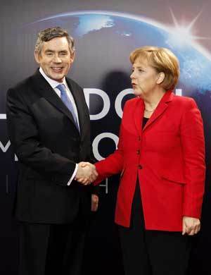 German Chancellor Angela Merkel (R) arrives at ExCel center and is greeted by British Prime Minister Gordon Brown for the summit of the Group of 20 Countries (G20) in London April 2, 2009.[Xinhua]