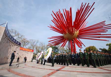 Chinese police present wreathes at a ceremony to pay their respects to deceased heros at a local cemetery for revolutionary martyrs in north China's coastal city of Tianjin, April 2, 2009, two days prior to the Qingming festival, or the tomb sweeping day, that falls on April 4. 