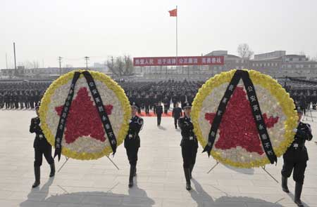 Chinese police present wreathes at a ceremony to pay their respects to deceased heroes at a local cemetery for revolutionary martyrs in north China's coastal city of Tianjin, April 2, 2009, two days prior to the Qingming festival, or the tomb sweeping day, that falls on April 4. 