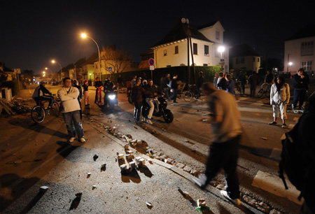 Local residents check the trash left after an anti-NATO demonstration in Neuhoof, ten kilometers to Strasbourg, France, April 2, 2009.