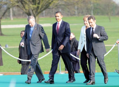 (L-R) NATO Secretary General Jaap de Hoop Scheffer, U.S. President Barack Obama, German Chancellor Angela Merkel and French President Nicolas Sarkozy reach France after crossing German-French border bridge, Passerelle Bridge, which connected German city Kehl and French city Strasbourg, on April 4, 2009. Leaders of NATO member states held a symbolic ceremony on the French-German border on Saturday to celebrate the 60th anniversary of the military alliance and the return of France as a full member.