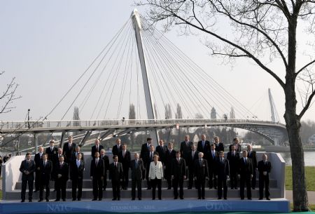 Leaders of NATO member states take a family photo after crossing German-French border bridge, Passerelle Bridge, which connected German city Kehl and French city Strasbourg, in Strasbourg, France, on April 4, 2009. Leaders of NATO member states held a symbolic ceremony on the French-German border on Saturday to celebrate the 60th anniversary of the military alliance and the return of France as a full member. 