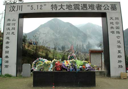 The cemetery for victims in the devastating earthquake striking southwest China's Sichuan Province May 12, 2008, is laid with flowers in Yingxiu Township of Wenchuan County, southwest China's Sichuan Province, April 4, 2009. Nearly 10,000 people gathered here on Saturday, the traditional Qingming Festival or Tomb-sweeping Day, to mourn for victims in last year's dissolving earthquake. 