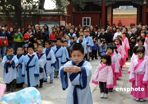 Children, dressed in Chinese traditional costumes, attend a sacrifice ceremony to Confucius at Guozijian (The Imperial College) in Beijing on Saturday, April 4, 2009, the traditional Qingming Festival or Tomb-sweeping Day. 