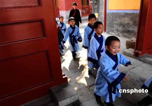 Children, dressed in Chinese traditional costumes, attend a sacrifice ceremony to Confucius at Guozijian (The Imperial College) in Beijing on Saturday, April 4, 2009, the traditional Qingming Festival or Tomb-sweeping Day. 