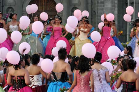 Over 300 15-year-old girls celebrate their birthdays together on the Constitution Square of Mexico City, capital of Mexico, April 4, 2009. During this special birthday party, these teenager girls danced and ate a huge birthday cake together. (Xinhua/Arturo)