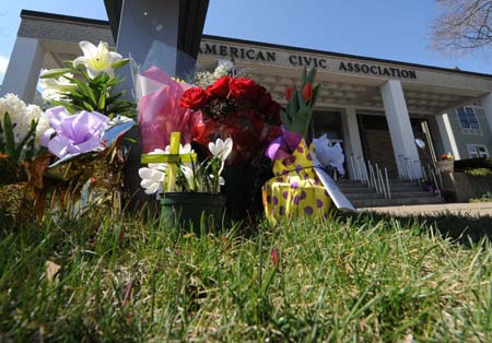 Flowers are placed by local residents in front of the American Civic Association in Binghamton, the United States, on April 5, 2009, to mourn for victims killed in Friday's shooting rampage. A total of 14 people of eight different countries of origin were killed in Friday's deadly shooting rampage in downtown Binghamton. [Xinhua]