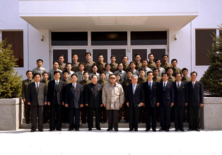 The photo released on April 6, 2009 by the Korean Central News Agency (KCNA) shows Kim Jong Il (5th L,front row), top leader of the Democratic People's Republic of Korea (DPRK), poses with staff members of the General Satellite Control and Command Centre after watching the launching of the experimental communications satellite Kwangmyongsong-2 on April 5.