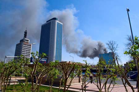 Smoke emits as a fire breaks out at a dormitory of migrant workers near Wanshoulu in western Beijing, China, April 6, 2009. There's no casualty reported at present. [Xinhua]