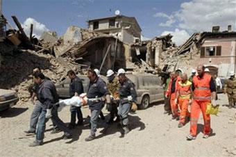 Rescuers carry a stretcher in the village of Onna, central Italy, Monday, April 6, 2009. [Sandro Perozzi/AP Photo] 