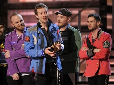 In this Feb. 8, 2009 file photo, Chris Martin, of Coldplay, accepts the award for best rock album at the 51st Annual Grammy Awards in Los Angeles, as bandmates Guy Berryman, left, Jonny Buckland and Will Champion, right, look on. 