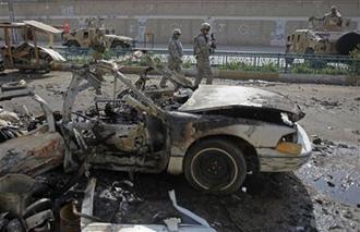 U.S. and Iraqi soldiers secure the area of a car bomb attack in Baghdad, Iraq, Monday, April 6, 2009. [Khalid Mohammed/AP Photo] 