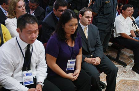 Former Peruvian President Alberto Fujimori's family, son Kenji (L-R), daughter congresswoman Keiko and son-in-law Mark Vito Villanella, attends Fujimori's trial at the Special Police Headquarters in Lima April 7, 2009. Fujimori was convicted and sentenced to 25 years in prison on Tuesday