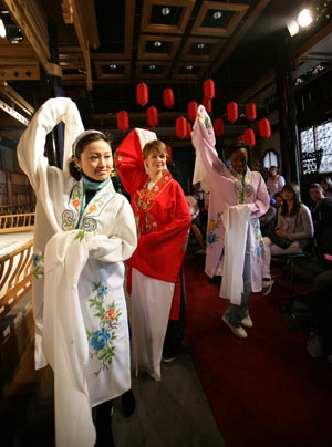 Some British middle school students learn to perform Kunqu Opera from a Chinese Kunqu actress (L 1st) in Suzhou city of east China's Jiangsu Province, April 8, 2009. Over thirty British middle school students visited China Kunqu Opera Museum in Suzhou on Wednesday and learned impromptu some skills of Kunqu performance, when they were on cultural exchange visits to Suzhou Foreign Languages School. [Xu Zhiqiang/Xinhua] 