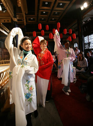 Some British middle school students learn to perform Kunqu Opera from a Chinese Kunqu actress (L 1st) in Suzhou city of east China's Jiangsu Province, April 8, 2009. Over thirty British middle school students visited China Kunqu Opera Museum in Suzhou on Wednesday and learned impromptu some skills of Kunqu performance, when they were on cultural exchange visits to Suzhou Foreign Languages School. (Xinhua/Xu Zhiqiang) 