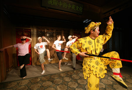 Some British middle school students learn to perform Kunqu Opera from a Chinese Kunqu actor in Suzhou city of east China's Jiangsu Province, April 8, 2009. Over thirty British middle school students visited China Kunqu Opera Museum in Suzhou on Wednesday and learned impromptu some skills of Kunqu performance, when they were on cultural exchange visits to Suzhou Foreign Languages School. (Xinhua/Xu Zhiqiang)