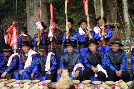 A group of ethnic Miao men are poised for the sacrificial ceremony during the fiesta of Guzang (to bury the drum) Festival, at the Yangfang Village, Taijiang County, southwest China's Guizhou Province, April 8, 2009. 