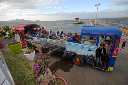 Residents ride on a bus near the Managua Lake, in Managua, capital of Nigaragua, April 9, 2009, during the Holy Week Holidays. The Holy Week, the second week in April, marks the Biblical story of crucifixion of Jesus Christ on the first Friday of April. (Xinhua/Oscar Navarrete)