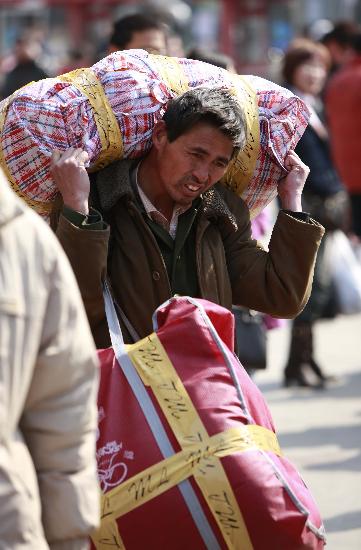 A migrant worker arrives in a railway station to try to find a job in the city.