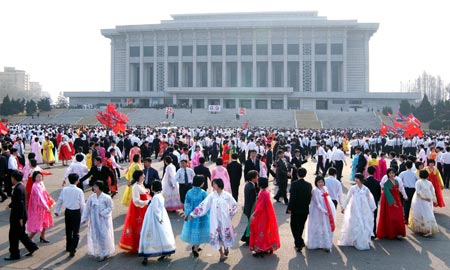 In this photo released by the Democratic People's Republic of Korea's (DPRK) official media Korean Central News Agency (KCNA), people dance during a ball to celebrate the reelection of Kim Jong-Il, the top leader of the DPRK, as chairman of the DPRK National Defence Commission (NDC), in Pyongyang April 9, 2009. 