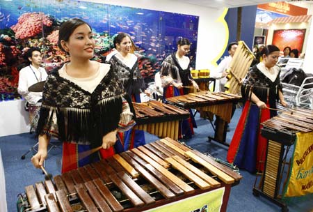 Girls perform traditional percussion instruments at the Philippines stand during the World Travel Fair 2009 in Shanghai, east China, on April 9, 2009. The fair, opening on Thursday at the Shanghai New International Expo Center, attracted more than 450 exhibitors from over 50 countries and regions. (Xinhua/Pei Xin) 