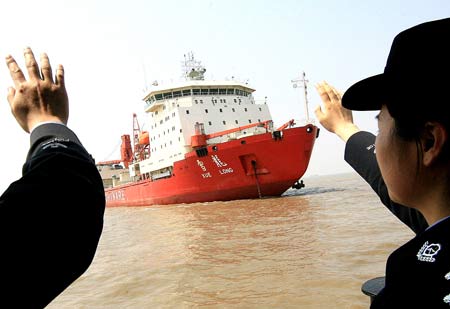 Police officers of the Shanghai Wusong frontier inspection station wait for the arrival of the Chinese Antarctic exploration vessel, 'Snow Dragon,' in Shanghai, east China, on April 9, 2009. 