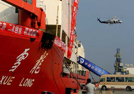 A rescuing helicopter flies over China's Antarctic exploration ship 'Xuelong' near the estuary of the Yangtze River in east China April 12, 2009. A mechanic was missing and the three other crew members were rescued after the helicopter taking off from China's Antarctic exploration ship 'Xuelong' crashed into the East China Sea off Shanghai Sunday.