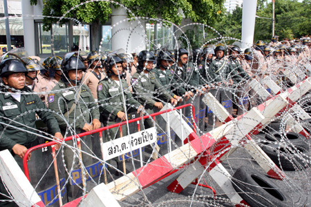 Soldiers guard beside barricades at the front gate of the Royal Cliff Beach Resort Hotel, the venue of the 14th ASEAN Summit and Related Summits, in Pattaya, Thailand, April 11, 2009. A scheduled 12th ASEAN-China Summit was postponed on Saturday due to anti-government 'red shirt' blocked all main roads in Pattaya, Thailand's acting government spokesman Panitan Wattanayakorn said. [Xinhua]