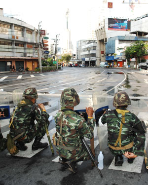 Thai army soldiers guard at the Din Daeng intersection in Bangkok, capital of Thailand, on April 13, 2009. At least 77 were wounded when hundreds of army soldiers and anti-government protesters clashed in Bangkok early Monday morning, Thai media reports. [Xinhua]