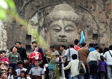 Tourists visit the Longmeng Grottoes in Luoyang City, central China's Henan Province. 