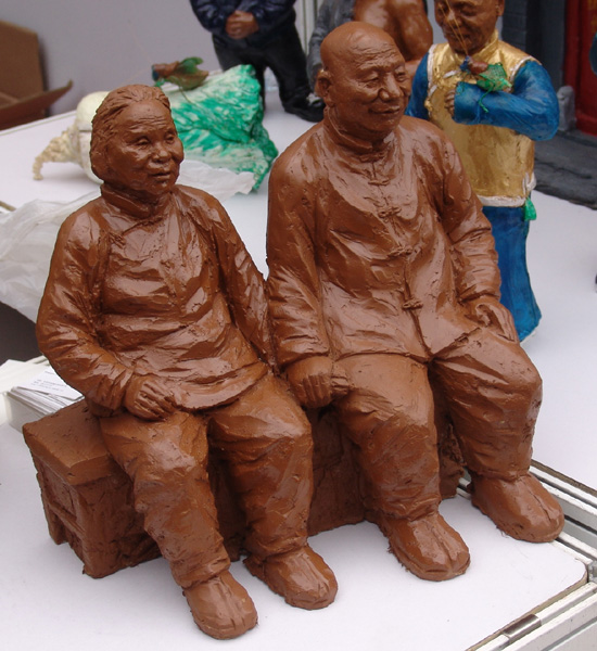 A model of an elderly couple by clay artist Zhao Qingjie is displayed at the launch ceremony of the national tourism action plan in Wangfujing Street, Beijing, April 11, 2009. [Wang Zhiyong/China.org.cn] 