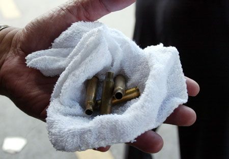 Anti-government protestors display bullets and tear gas cans during a rally at the Government House in Bangkok, capital of Thailand, April 13, 2009. Anti-government protestors have set up several blocks to control the people who wanted to enter the site of the rally. 