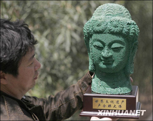 Li Mingfu, with the Mass Art Centre of Luoyang City, Henan Province, displays his work - a replica of Buddha Losana statue which is located in the Longmen Grotto of the same provice, April 6, 2009.