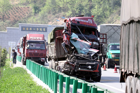 A badly damaged truck is seen beside the Xishang Expressway in northwest China's Shaanxi Province, April 14, 2009. [Wu Anbiao/Xinhua] 